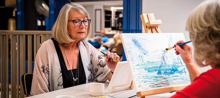 People painting with watercolours on Spirit of Adventure